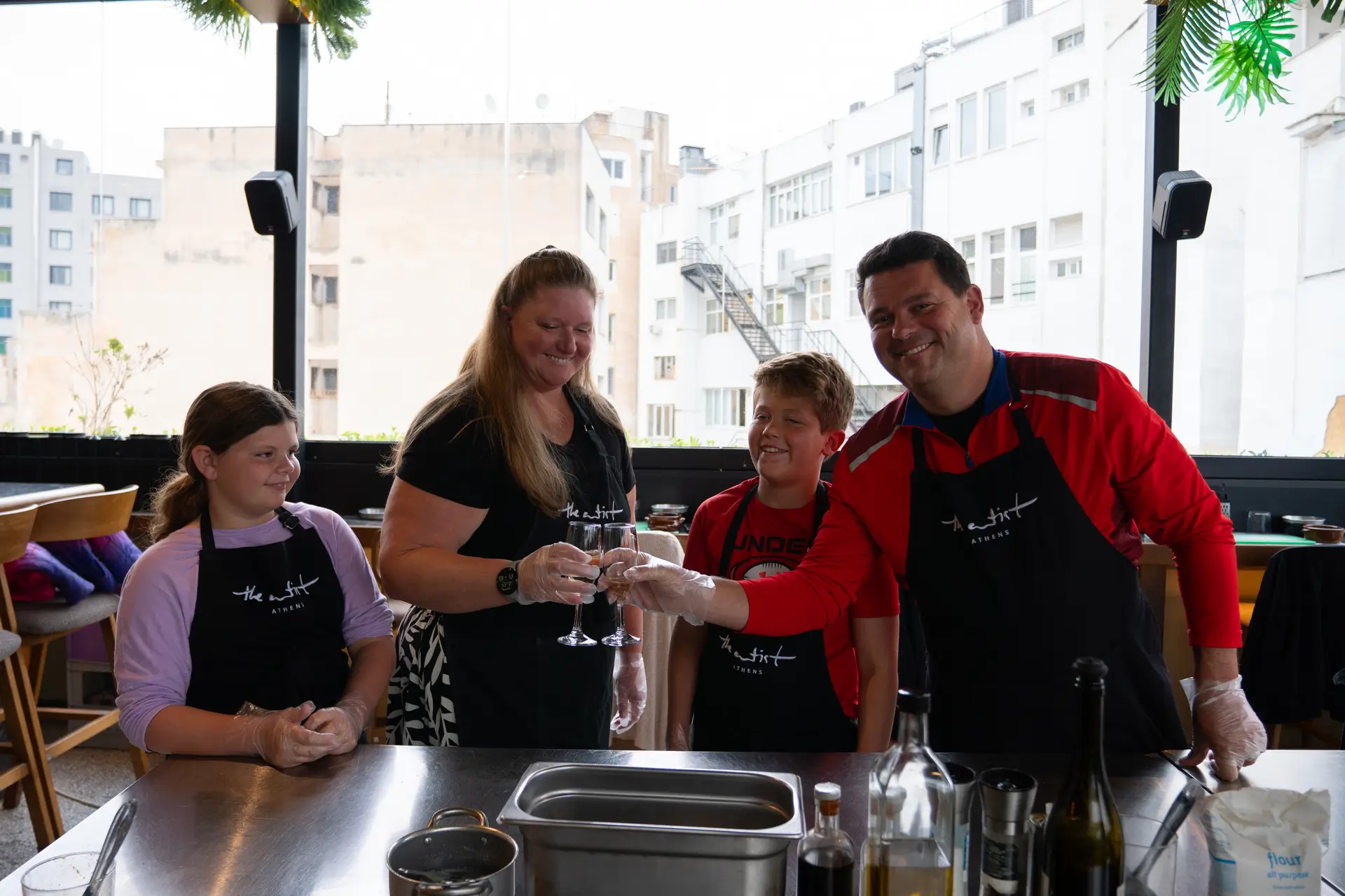 Family raising champagne glasses at the end of the cooking class — pure joy