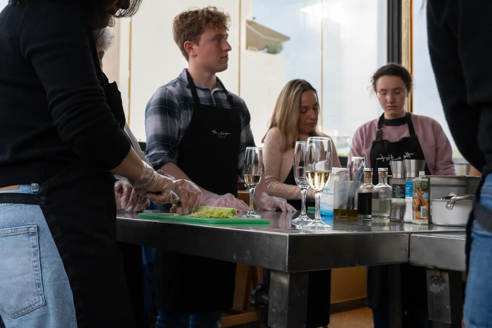 Participants focused on prep work — cutting fresh vegetables for tzatziki