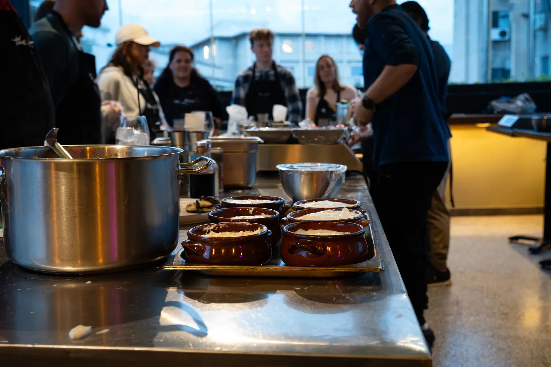 Moussaka pots assembled and ready — the group gathering before the rooftop dinner